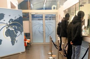 Clients at a branch of an international money transfer company. Remittances are a major part of transnational family support/Photo: AfricanCourierMedia